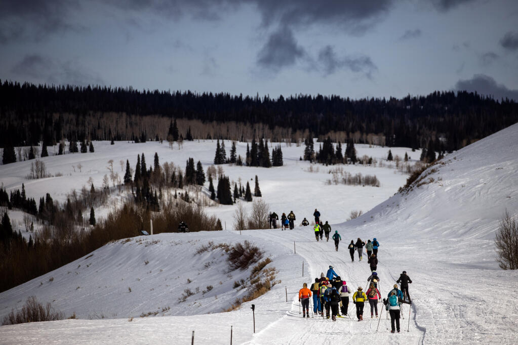 Participants in The Drift, a winter ultra marathon race, near Cora, Wyoming, on March 14, 2021.  In the throes of a pandemic that has made the indoors inherently dangerous, tens of thousands more Americans than usual have flocked outdoors. (Max Whittaker/The New York Times)