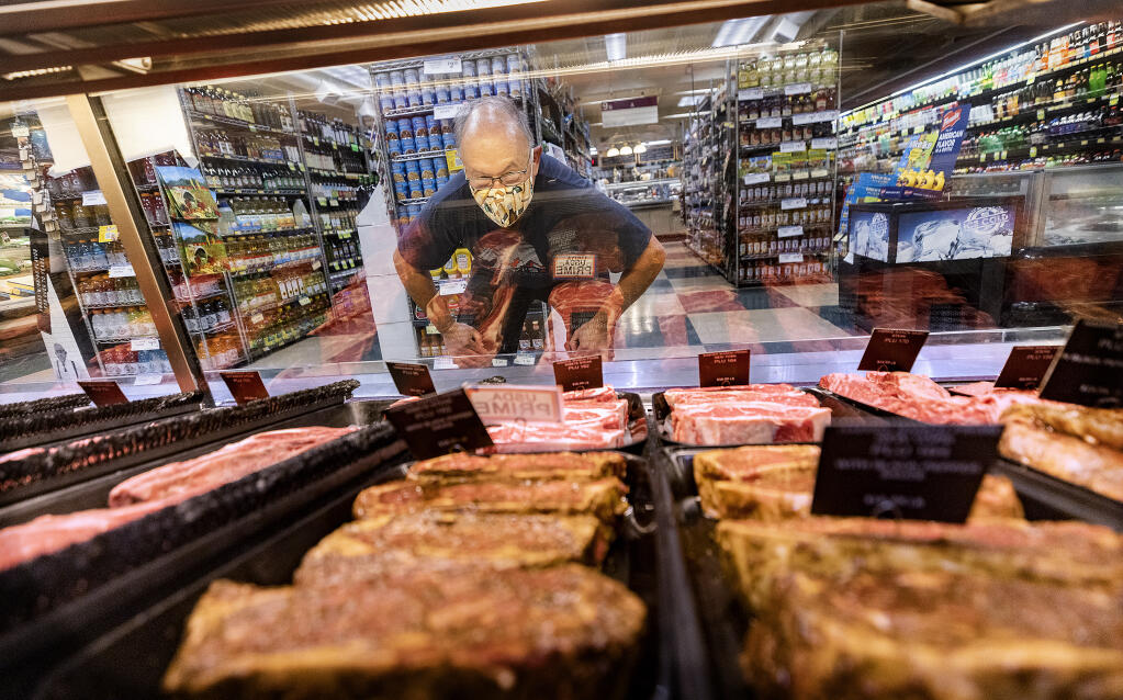 Jim Pantelone checks out the meat department at Molsberry's Market in Larkfield on Wednesday, June 16, 2021. Grocery prices from red meats and chicken to cereal and packaged pasta are taking a bigger bite out of people's wallets as prices increase on essential food items.  (John Burgess/The Press Democrat)