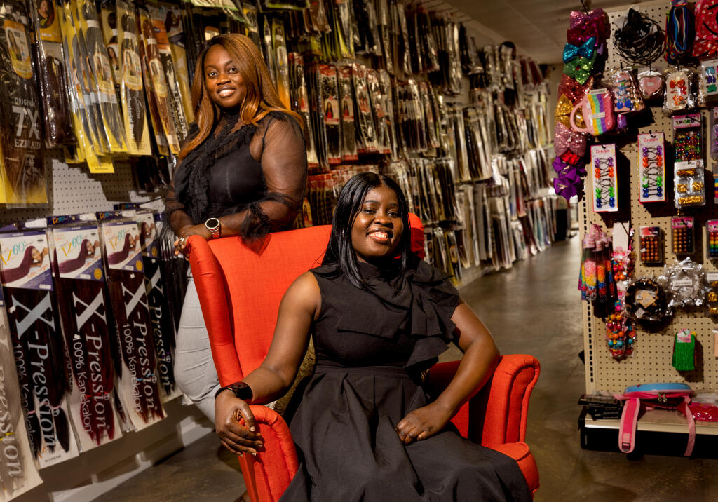 Sisters Eva Karikari, left, and Tina Apraku opened E & E Beauty Supply Bar in Santa Rosa May 31, 2023, for locals who had to drive to Vallejo or Oakland for their hair extensions, wigs, weaves, twist and crochet and more. (John Burgess/The Press Democrat)