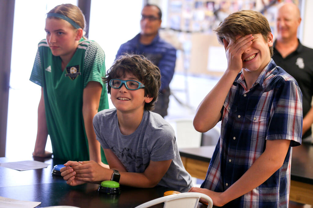 Mateo De La Cruz, right, Nolan Brenner, and Lilian Campbell compete in a math tournament put on by Math For Everyone in Healdsburg, Sunday, April 30, 2023. (Christopher Chung / The Press Democrat)
