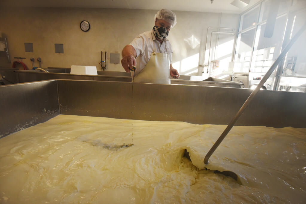 Keith Adams adding Roqueforti culture which creates the blue-colored mold in his Stilton-style Bodega Blue cheese at Wm. Cofield Cheesemakers in The Barlow in Sebastopol on Wednesday, Oct. 21, 2020. (Erik Castro / for The Press Democrat)