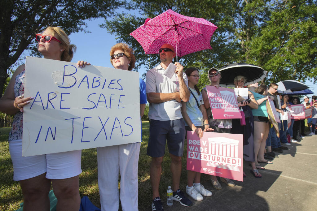 FILE - Linda Banes, left, and Ethelene Marshall stand with anti-abortion demonstrators as they gathered to sing and pray outside Planned Parenthood in Houston, June, 24, 2022, after the U.S. Supreme Court overturned Roe v Wade. (Brett Coomer/Houston Chronicle via AP, File)