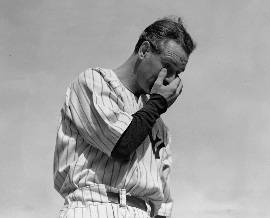 FILE - New York Yankees' Lou Gehrig wipes away a tear while speaking during a sold-out tribute at Yankee Stadium in New York, in this July 4, 1939, file photo.  (AP Photo/Murray Becker, File)