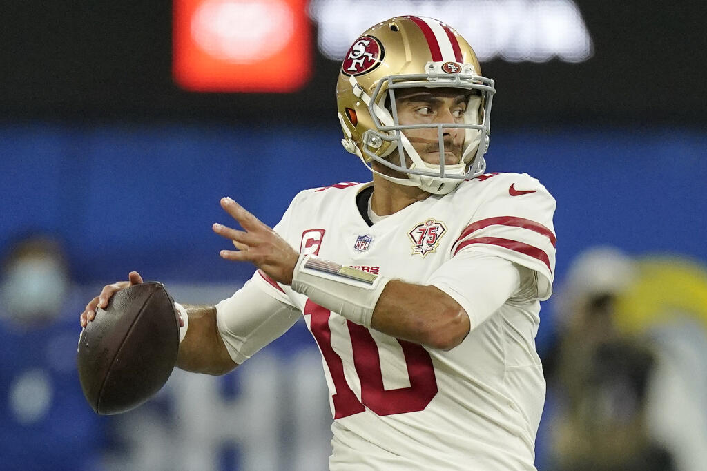 The San Francisco 49ers’ Jimmy Garoppolo looks to throw during the second half of the NFC championship game against the Los Angeles Rams on Jan. 30, 2022, in Inglewood. (Mark J. Terrill / ASSOCIATED PRESS)