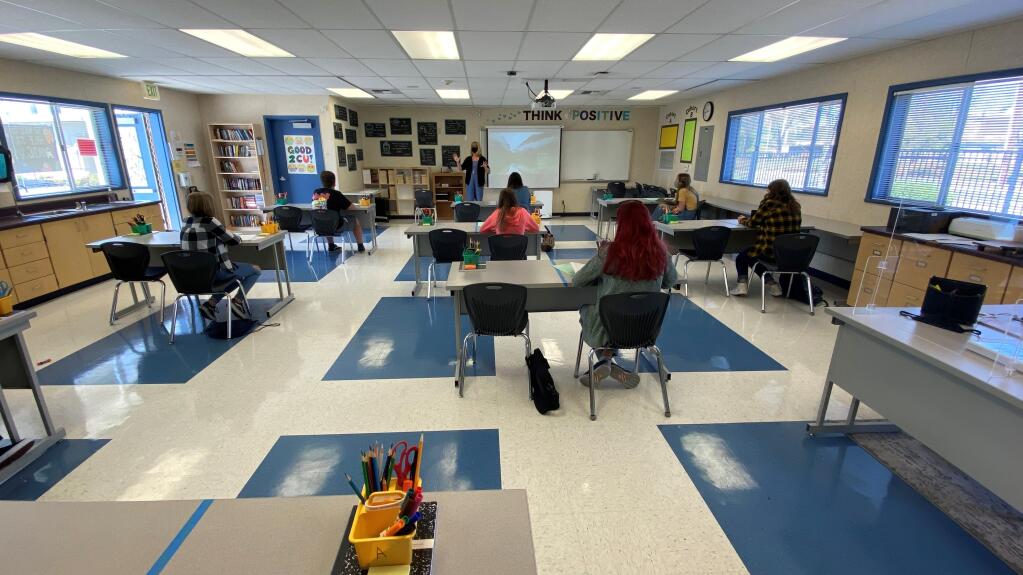 Teacher Samantha Tuor reviews an assignment with her class at Rincon Valley Charter School's Matanzas campus on Monday, March 29, the first day that students returned for in-person learning. (Kaylee Tornay/Press Democrat)