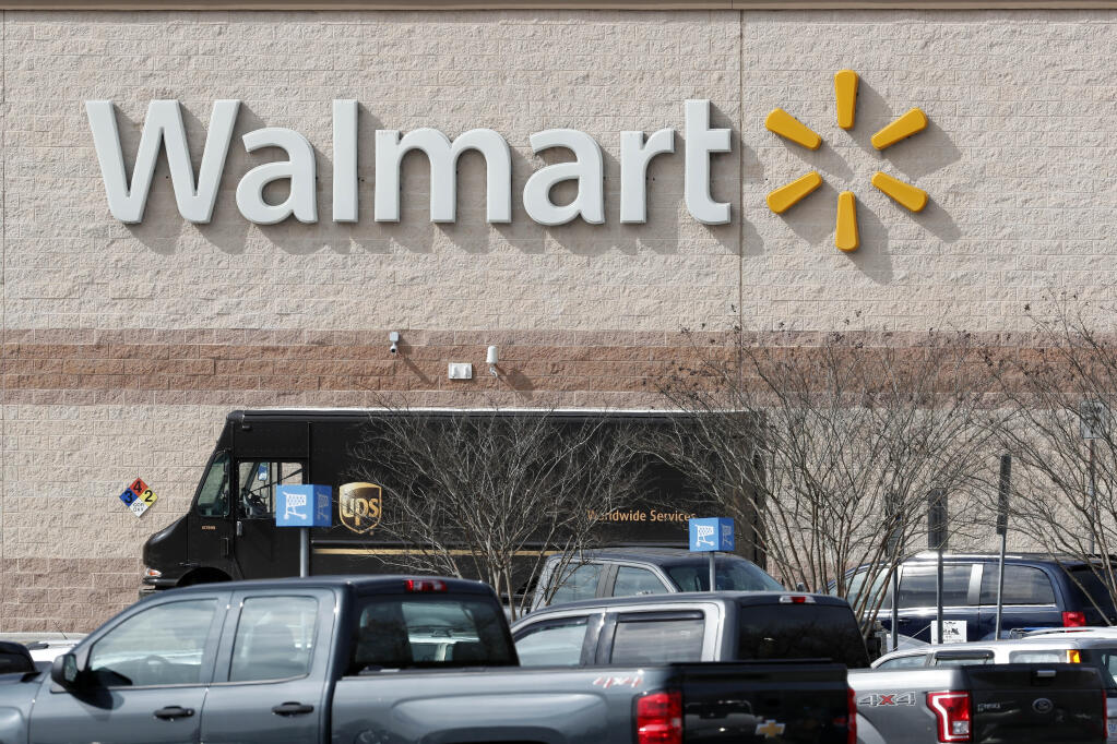 A UPS truck is parked in front of this Walmart store in Mebane, North Carolina on March 17, 2020. The retailer’s new Walmart GoLocal service would compete with such logistics companies and same-day-delivery e-tailers like Amazon. (AP Photo/Gerry Broome)