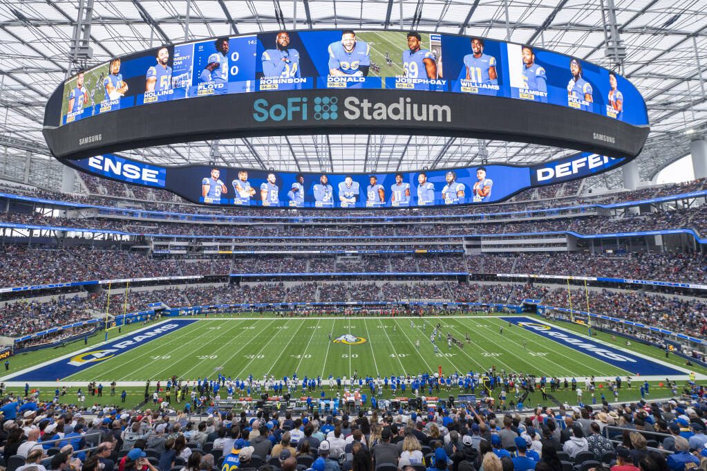 FILE - This is a general overall interior view of SoFi Stadium as the Los Angeles Rams takes on the Tampa Bay Buccaneers in an NFL football game Sunday, Sept. 26, 2021, in Inglewood, Calif. A late-season surge in COVID-19 cases had the NFL in 2021 looking a lot like 2020, when the coronavirus led to significant disruptions, postponements and changing protocols. The emerging omicron variant figures to play a role all the way through the playoffs, including the Super Bowl in Los Angeles, where California has always been aggressive with policies to combat the spread of the virus. (AP Photo/Kyusung Gong, File)