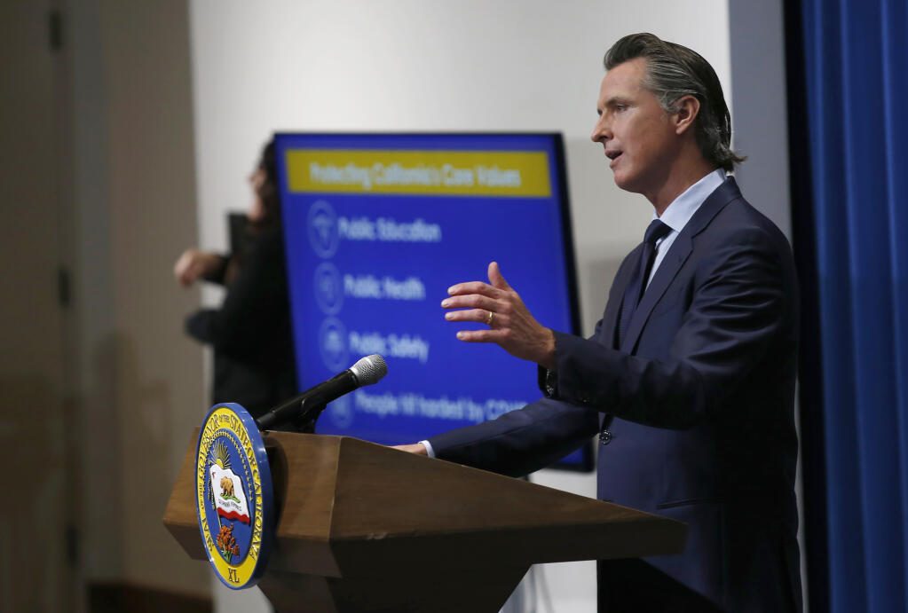 FILE - In this May 14, 2020, file photo, California Gov. Gavin Newsom discusses his revised 2020-2021 state budget during a news conference in Sacramento, Calif. Gov. Newsom on Tuesday, Jan. 5, 2021, proposed a $4 billion spending plan he says will create jobs and help small businesses recover from the economic downturn brought on by the coronavirus pandemic. (AP Photo/Rich Pedroncelli, Pool, File)