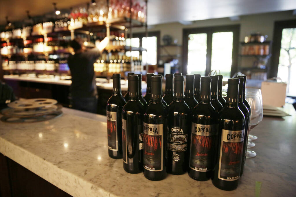 FILE - Bottles of Apocalypse Now Red Blend wine stand on a tasting bar counter at the Francis Ford Coppola Winery on May 21, 2020, in Geyserville, Calif. The California Legislature approved a measure Wednesday, Aug. 31, 2022, that would add wine and distilled spirits containers to the state's recycling program, sending it to Gov. Gavin Newsom. (AP Photo/Eric Risberg, File)