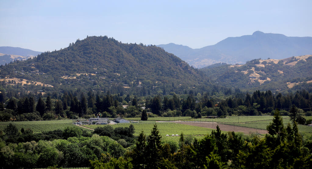 In the shadow of Mt. St. Helena, Fitch Mountain, seen at left on May 27, 2021 from Healdsburg , is susceptible to the fall winds that rip over the Mayacamas Mountains, leaving the east side of Fitch susceptible to fire, Thursday, May 27, 2021 in Healdsburg.  (Kent Porter / The Press Democrat)