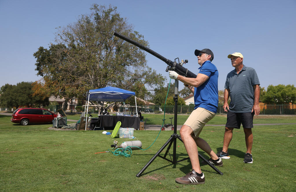 Andrew Grossman, left, fires his golf ball out of a ball cannon, under the supervision of Jeff Siegel, to raise money for Dogwood Animal Rescue, during the Coldwell Banker Golf Tournament hosted by Guaranteed Rate Infinity at the Windsor Golf Club on Friday, September 3, 2021.  (Christopher Chung/ The Press Democrat)