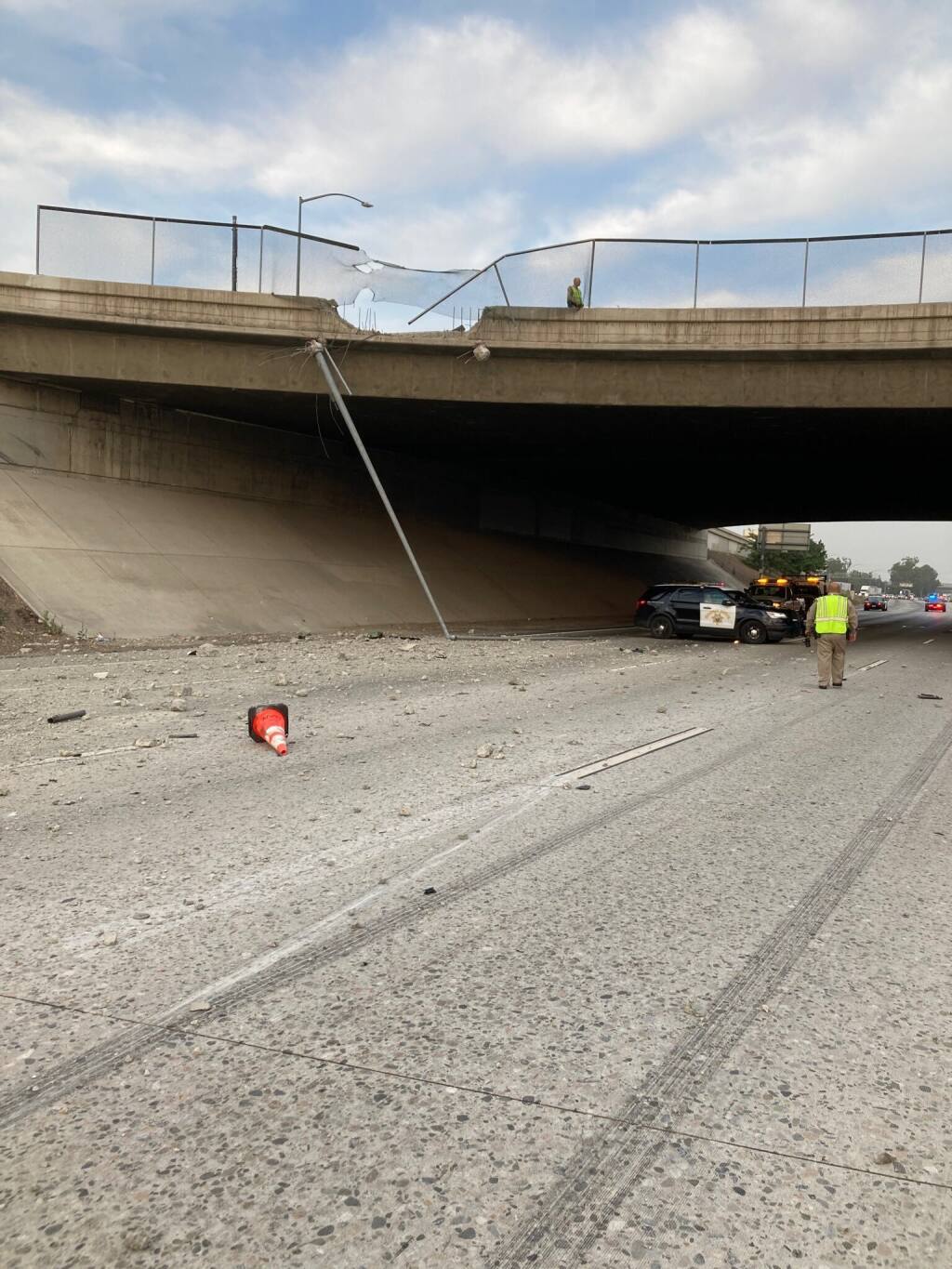 This photo provided by the California Highway Patrol Rancho Cucamonga shows a damaged concrete barrier on a Southern California overpass where a pickup truck crashed through onto the road below on Tuesday, June 29, 2021 in Fontana, Calif. The pickup truck driver was killed when he crashed through the fencing and concrete barrier of the overpass and flew over the edge and smashed onto the freeway below early Tuesday, authorities said. The man, whose name has not been released, was driving his 2005 Ford pickup around 4:10 a.m. at a high speed on Interstate 10 in Fontana, the California Highway Patrol said in a news release. (CHP Rancho Cucamonga via AP)