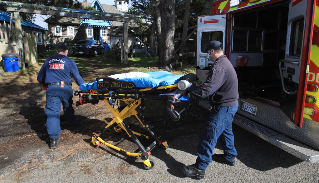 Bodega Bay Fire Protection District firefighter-paramedics  Tyler Reynolds, left, and Josh Menzies, are called to a medical aid in Bodega Bay, Friday, Feb. 12, 2021. (Kent Porter / The Press Democrat)