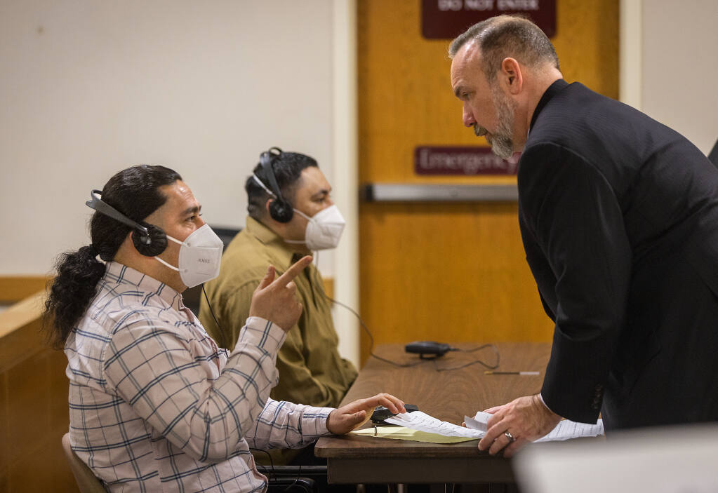 Attorney Gabriel Quinnan meets with client Fredi Lopez-Flores before the continuation of his trial, along with co-defendant Christian Quintero, right, on multiple charges including kidnapping, robbery and multiple counts related to rape in Sonoma County Superior Court in Santa Rosa on Wednesday, March 9, 2022.  (John Burgess / The Press Democrat)