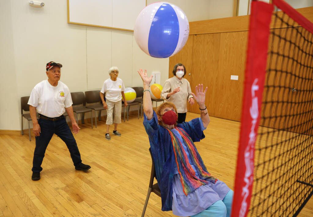 Mimi Herschkowitz, front, hits a beachball, while playing volleyball with Sergio Montoya Carrillo, left, Evangelina Helena Montoya, and Irmtraut Gangl at the Person Senior Wing of the Finley Community Center in Santa Rosa, Wednesday, July 12, 2023. (Christopher Chung / The Press Democrat)