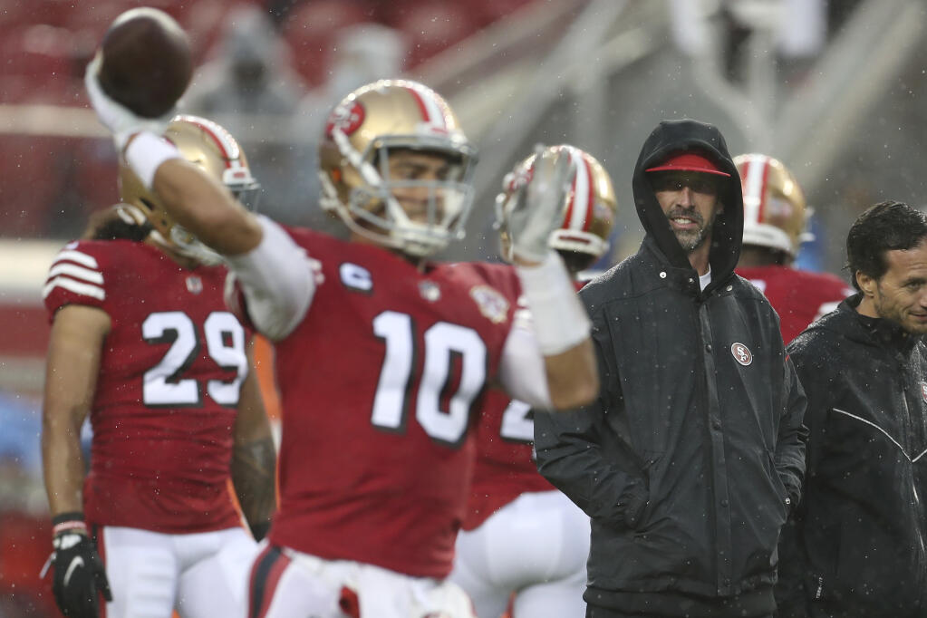 San Francisco 49ers head coach Kyle Shanahan, right, watches as quarterback Jimmy Garoppolo warms up before a game against the Indianapolis Colts in Santa Clara on Sunday, Oct. 24, 2021. (Jed Jacobsohn / ASSOCIATED PRESS)