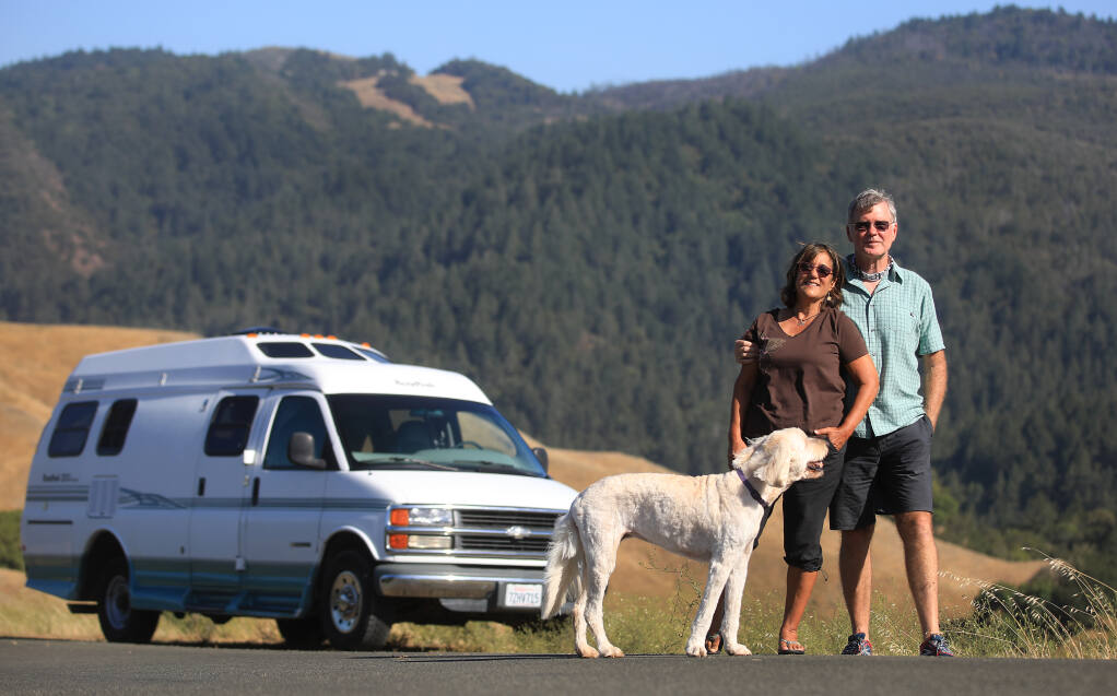 Santa Rosa residents Virginia and Clark Mason, with their dog Brandie, are hitting the road this summer in their RV. (Kent Porter / The Press Democrat)