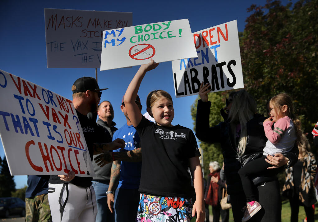 Laurelei Olpp, 10, protests against the upcoming COVID-19 vaccination requirement for students attending California schools in person. The demonstration took place outside the Sonoma County Office of Education in Santa Rosa, California, on Monday, October 18, 2021. (Beth Schlanker/The Press Democrat)