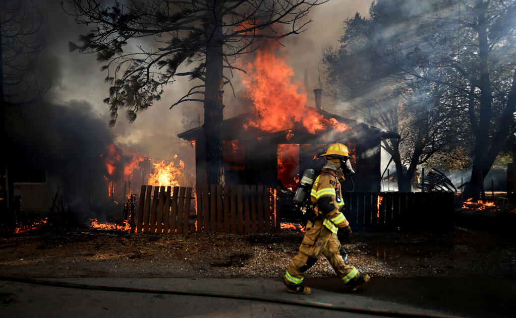 Firefighters from around Lake County converged on a fire that burned five homes in Clearlake Oaks, Sunday, July 18. 2021.  (Kent Porter / The Press Democrat)