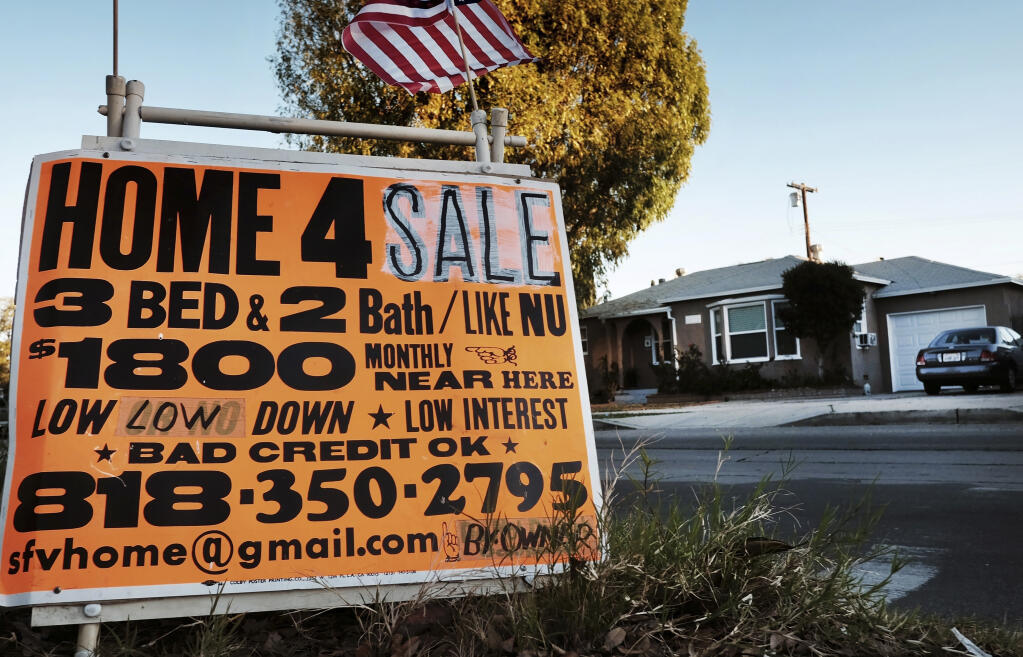 FILE - This Jan. 17, 2015 photo shows a sign advertising a house for sale in Los Angeles. (AP Photo/Richard Vogel, File)