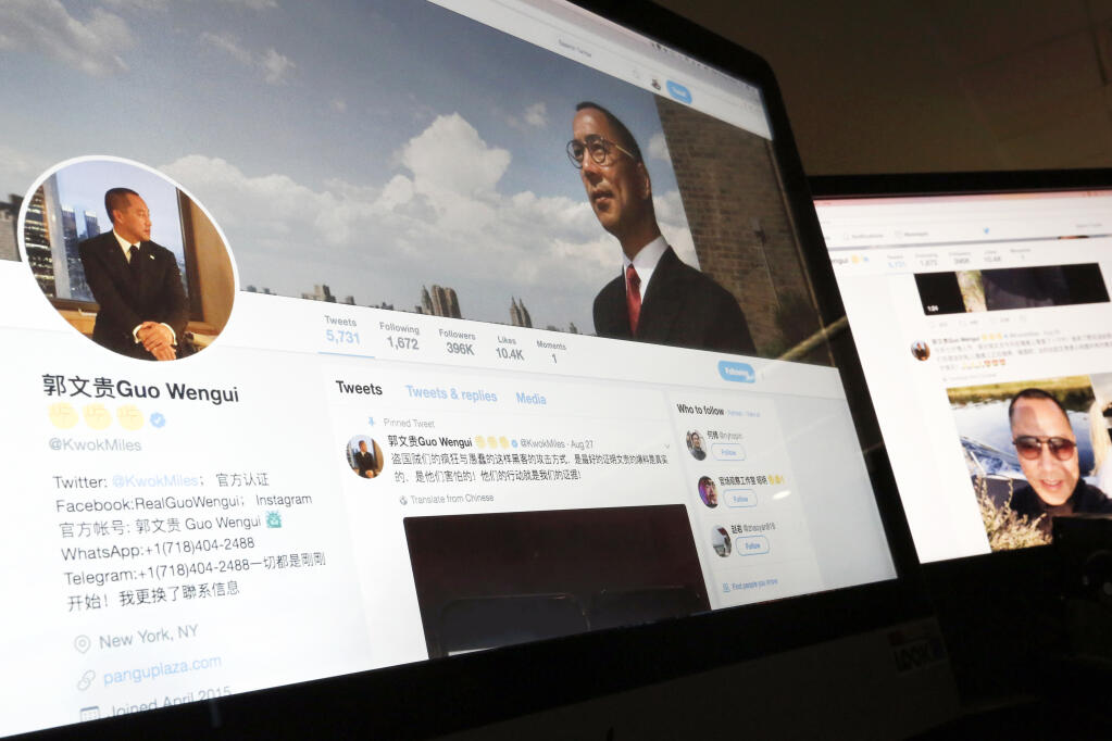 FILE - A Twitter page of Chinese exiled businessman Guo Wengui is seen on a computer screen in Beijing, Aug. 30, 2017. The self-exiled Chinese businessman long sought by the government of China, and known for cultivating ties to Trump administration figures including Steve Bannon, was arrested Wednesday, March 15, 2023, in New York on charges that he oversaw a billion dollar fraud conspiracy. Guo Wengui, also known as Ho Wan Kwok, and his financier, Kin Ming Je, were charged in an indictment in Manhattan federal court with various charges, including wire, securities and bank fraud, authorities said. (AP Photo/Andy Wong, File)