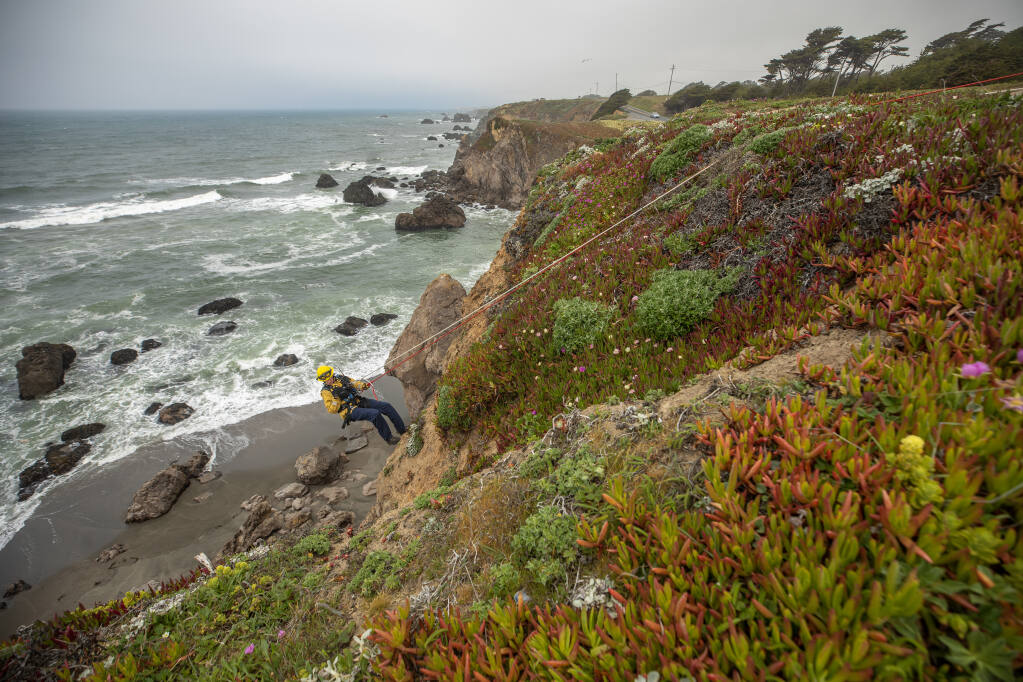 Sonoma County Fire District firefighters from Bodega Bay’s station 10, work on their cliff rescue skills off Coleman Valley Overlook along Highway 1 during training, Friday, May 19, 2023. Firefighter Ryan Vincent descends to the beach from the staging area. (Chad Surmick / The Press Democrat file)