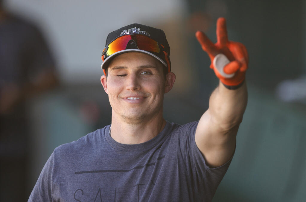 Drew Robinson of the Sacramento River Cats waves from the dugout before a game against the Las Vegas Aviators on May 27, 2021 in Sacramento. Robinson attempted suicide on April 16, 2020 by shooting himself in the temple. Although he lost vision in one of his eyes, he has been able to make a full recovery. (Ezra Shaw / Getty Images)