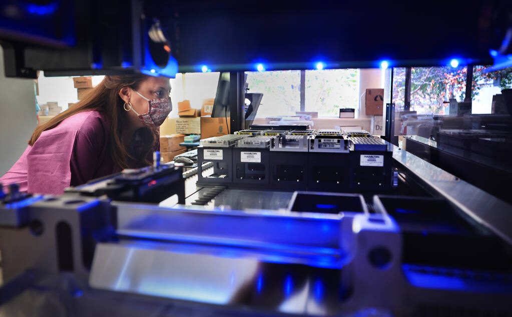 Lisa Critchett, a county health microbiologist checks the progress of genetic sequencing for COVID testing samples in state of the art genotyping equipment, Tuesday, July 13, 2021 at Sonoma County Public Health in Santa Rosa.  (Kent Porter / The Press Democrat) 2021