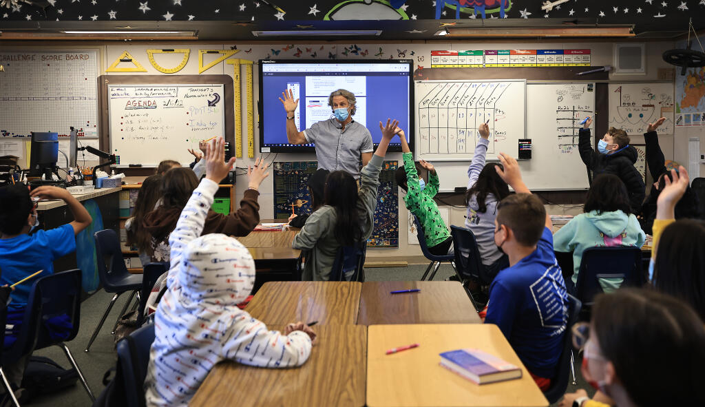 John Menth, a sixth-grade teacher at San Miguel Charter School, runs through a math problem with his students, Wednesday, Feb. 16, 2022. Even as California has lifted the mask mandate, school's are still required to keep face covering procedures in place. (Kent Porter / The Press Democrat) 2022