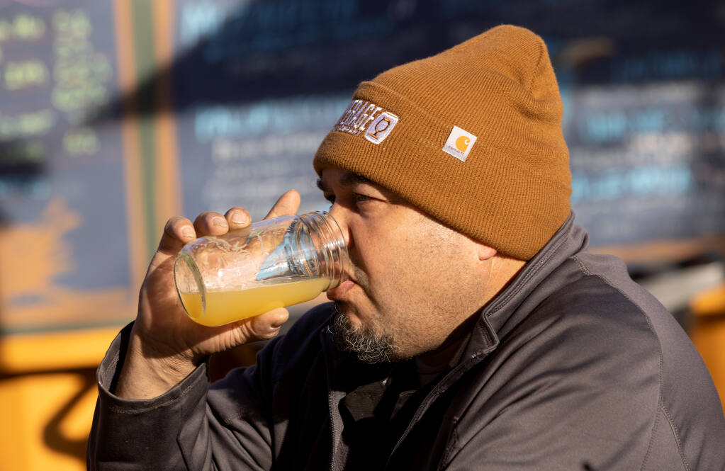 Martine Avalos enjoys a beer after work at Mitote Food Park in Santa Rosa, Tuesday, Jan. 24, 2023. Restrictions on where you can drink at Mitote Food Park have been relaxed so patrons can wander in the area with an adult beverage. (John Burgess/The Press Democrat)