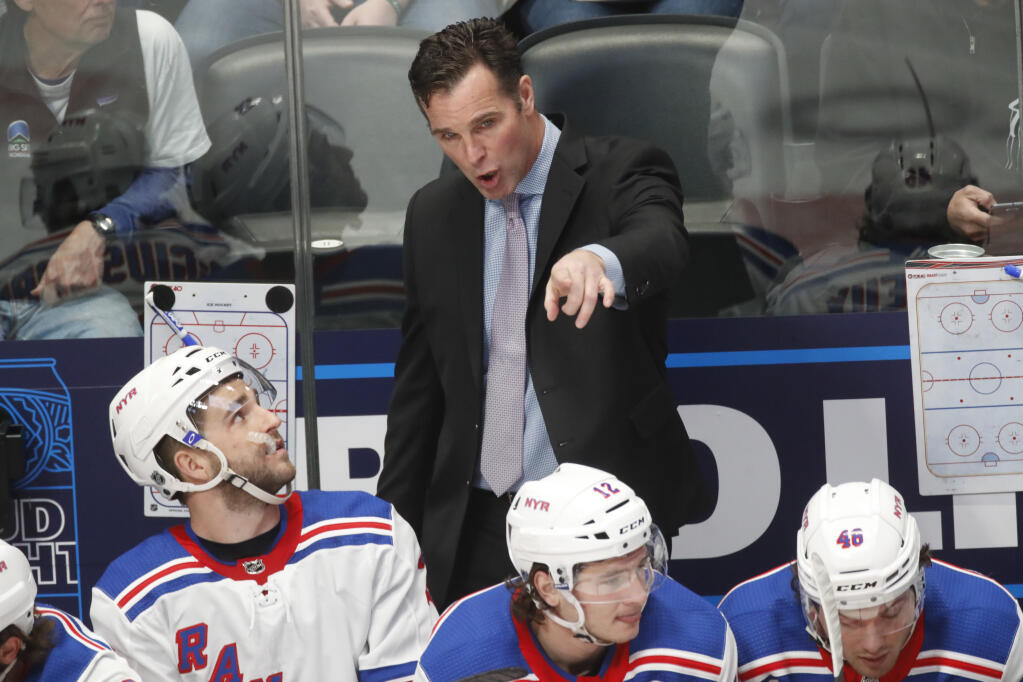 FILE - New York Rangers head coach David Quinn talks to players in the first period of an NHL hockey game Wednesday, March 11, 2020, in Denver. The Sharks hired former New York Rangers coach David Quinn as their new head coach, the Sharks announced Tuesday, July 26, 2022.(AP Photo/David Zalubowski, File)