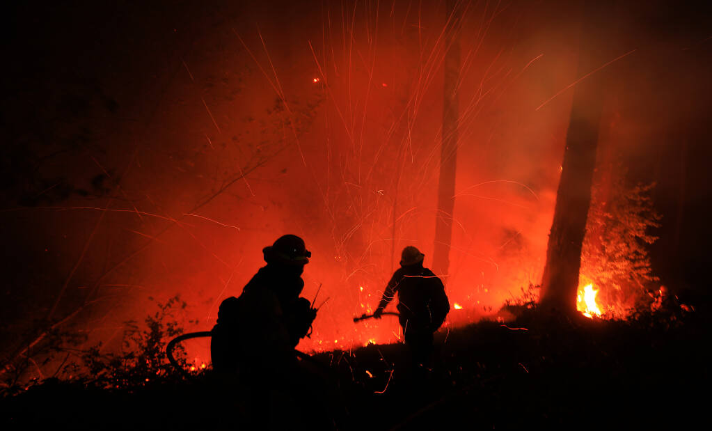 Firefighters battle a flare-up on the Glass Fire just below Highway 29 on Mt. St. Helena, Thursday, Oct. 1, 2020.  (Kent Porter / The Press Democrat) 2020