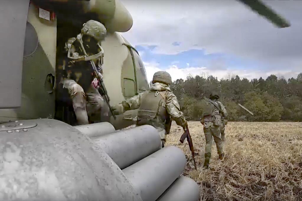 FILE - In this handout photo taken from video and released by Russian Defense Ministry Press Service on July 30, 2022, Russian Army soldiers leave a military helicopter during a mission at an undisclosed location in Ukraine. (Russian Defense Ministry Press Service via AP, File)