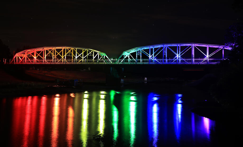 The Healdsburg Memorial Bridge is displayed in colors of the Rainbow flag, Tuesday, June 7, 2022, in celebration of Pride Month throughout June.  (Kent Porter / The Press Democrat) 2022