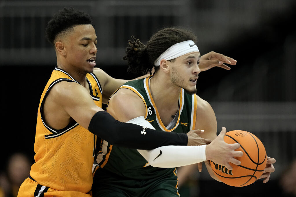 Wichita State guard Xavier Bell, left, tries to steal the ball from San Francisco guard Tyrell Roberts during the first half Tuesday, Nov. 22, 2022, in Kansas City, Missouri. (Charlie Riedel / ASSOCIATED PRESS)