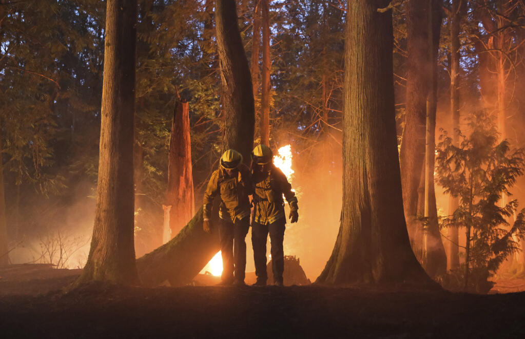 This image released by CBS shows Jordan Calloway as Jake Crawford, left, and Jules Latimer as Eve Oliver in a scene from “Fire Country.” (Bettina Strauss/CBS via AP)
