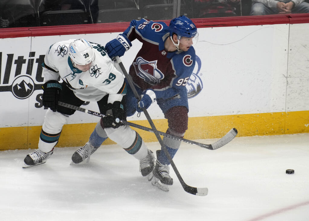 San Jose Sharks center Logan Couture, left, gets tangled up with Colorado Avalanche left wing Andre Burakovsky while pursuing the puck in the first period on Thursday, March 31, 2022, in Denver. (David Zalubowski / ASSOCIATED PRESS)