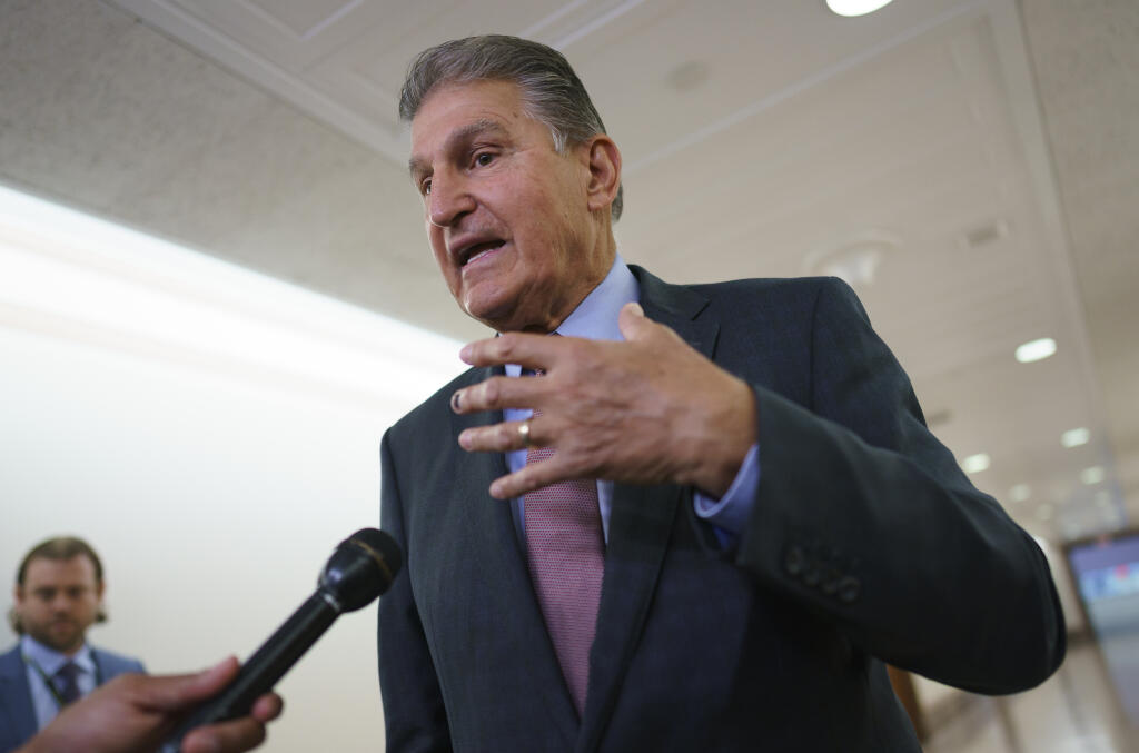 FILE - Sen. Joe Manchin, D-W.Va., speaks to reporters outside the hearing room where he chairs the Senate Committee on Energy and Natural Resources, at the Capitol in Washington, July 19, 2022. Manchin announced Wednesday, July 27, that he had reached an expansive agreement with Senate Majority Leader Chuck Schumer which had eluded them for months on health care costs, energy and climate issues, taxing higher earners and large corporations and reducing federal debt. (AP Photo/J. Scott Applewhite, File)