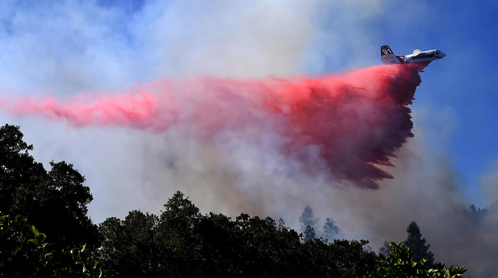 Near the onset of a heatwave, a Cal Fire air tanker is used to corral flames on the Hog Fire northwest of Cloverdale, Tuesday, July 11, 2023.  (Kent Porter / The Press Democrat)