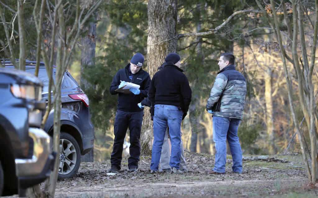 Law enforcement personnel investigate the scene of multiple shootings on Arkabutla Dam Road in Arkabutla, Miss on Friday, Feb. 17, 2023. Six people were fatally shot Friday at multiple locations in a small town in rural Mississippi near the Tennessee state line, and authorities blamed a lone suspect who was arrested and charged with murder. (AP Photo/Nikki Boertman)
