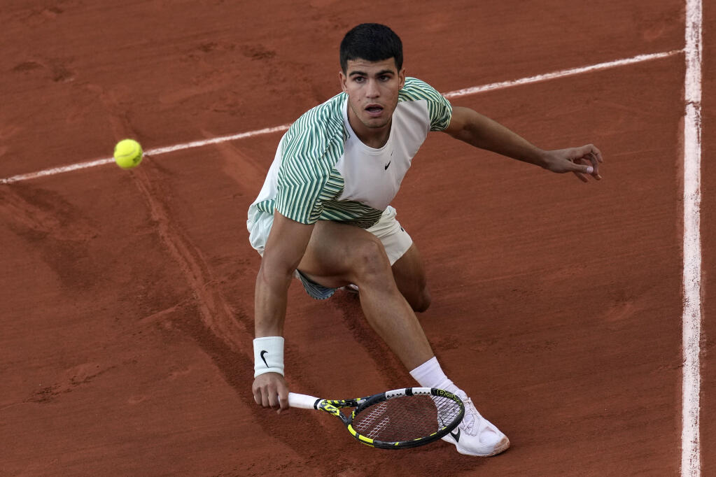 Spain's Carlos Alcaraz plays a shot against Italy's Flavio Cobolli during their first round match of the French Open tennis tournament at the Roland Garros stadium in Paris, Monday, May 29, 2023. (AP Photo/Christophe Ena)
