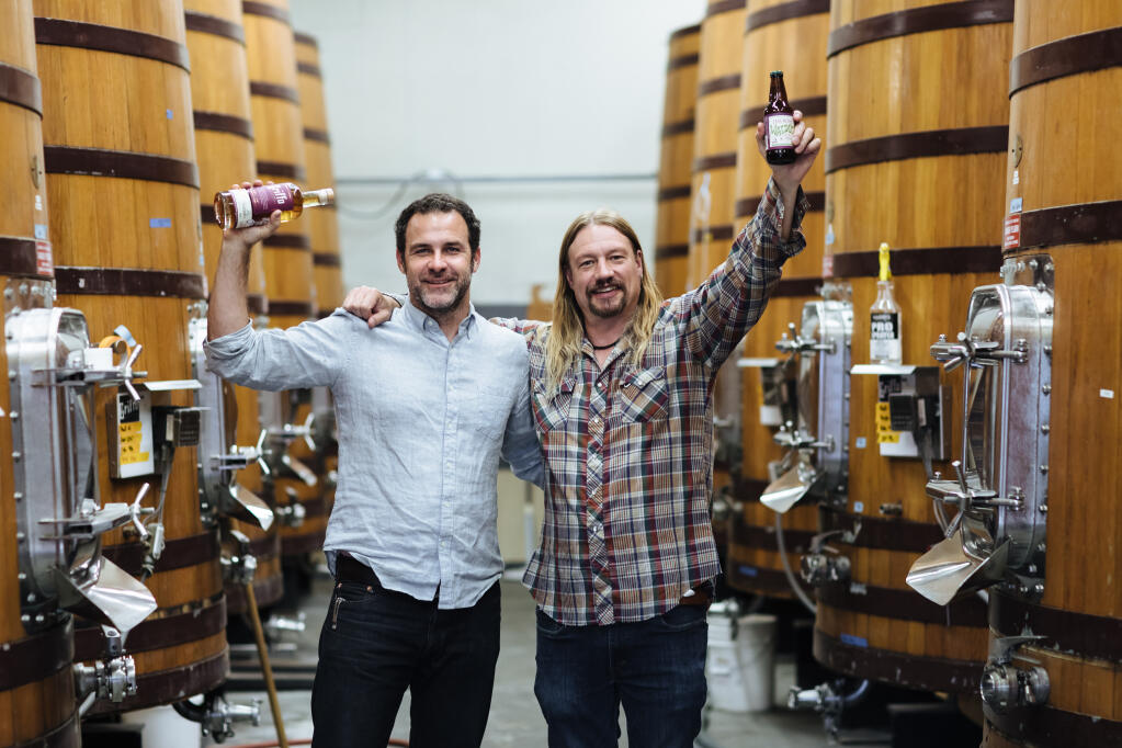 Mike Griffo, left, co-founder and head distiller at Griffo Distillery, and Jeremy Marshall, brewmaster at Lagunitas Brewing Co., celebrate the release of Still Waldos, a new single-malt whiskey. (Michael Woolsey)