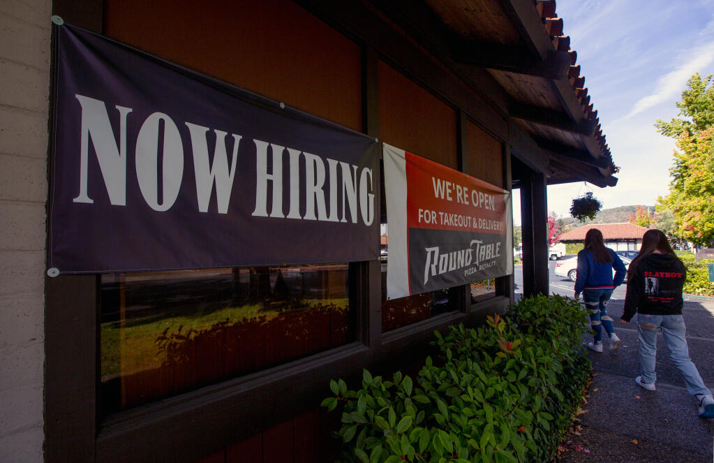 A sign indicates that jobs are available at Round Table Pizza in the Marketplace shopping center on Second Street West in Sonoma on Tuesday, Oct. 19, 2021. (Photo by Robbi Pengelly/Index-Tribune)