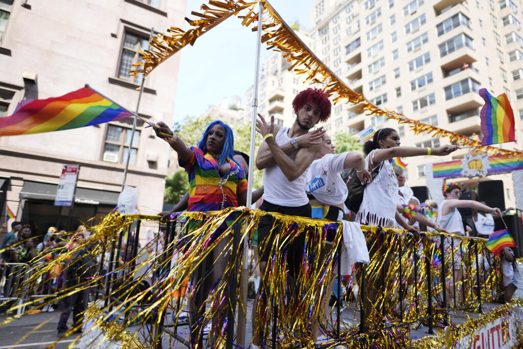 Paradegoers ride a float during the NYC Pride March on Sunday, June 26, 2022, in New York. (Charles Sykes / Invision)