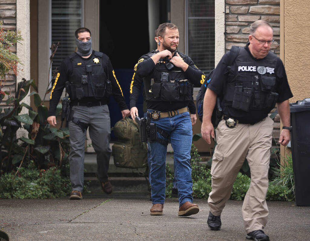 Detectives with the Sonoma County Sheriff's Office and a Petaluma police officer leave Dominic Foppoli's home in Windsor, Wednesday, Nov. 10, 2021. (Kent Porter / The Press Democrat) 2021