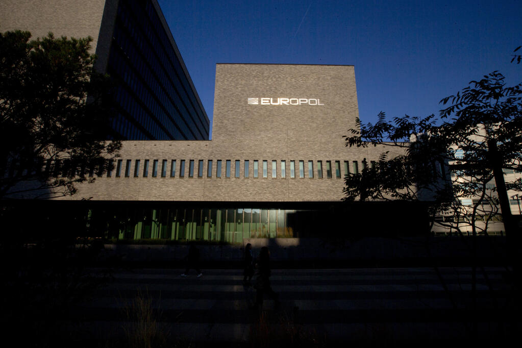 FILE- This Wednesday, Oct. 10, 2018, file photo shows the sun bouncing off the Europol headquarters in The Hague, Netherlands. Europol says law enforcement authorities in six different countries have joined forces to take down a “super cartel” of drugs traffickers controlling about one third of the cocaine trade in Europe. (AP Photo/Peter Dejong, File)