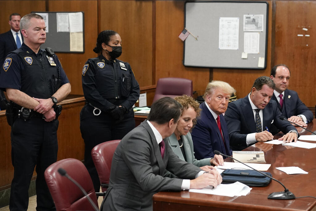 Former President Donald Trump appears in court for his arraignment, Tuesday, April 4, 2023, in New York.  Trump surrendered to authorities ahead of his arraignment on criminal charges stemming from a hush money payment to a porn actor during his 2016 campaign.   (AP Photo/Seth Wenig, Pool)